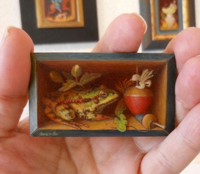 Petit peinture en trompe l oeil representant une grenouille dans une boite